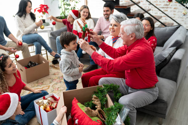 Grandparent giving gift to the grandchild during Christmas Family Gathering