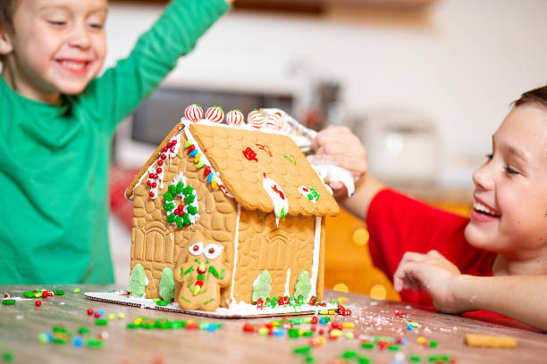 Kids decorating Gingerbread House at Christmas