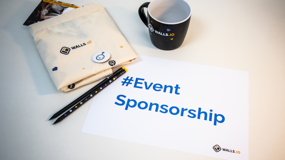 Branded sponsor swag and signage laid out for a trade show activation