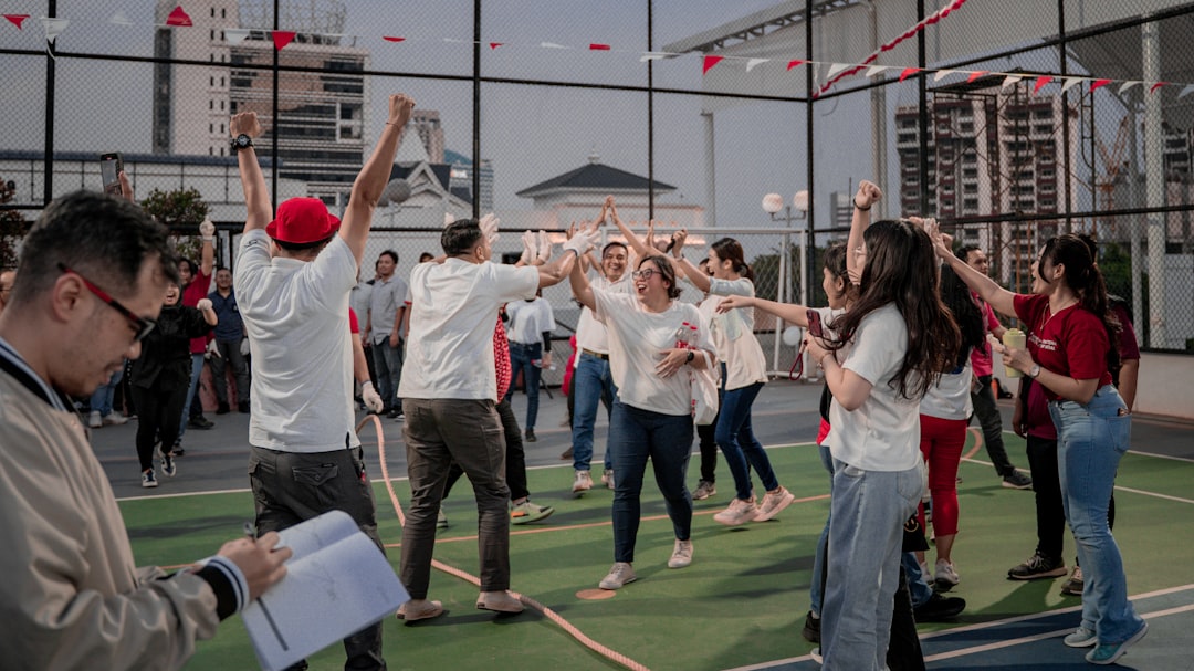 People celebrating outdoors with raised arms